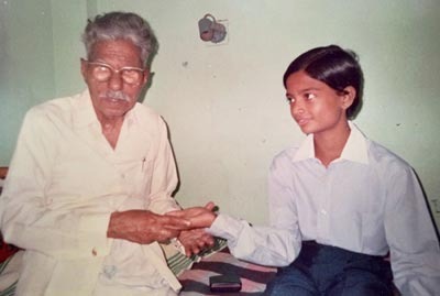 Master Ganesh getting trained by his grandfather at the age of 8 in palmistry